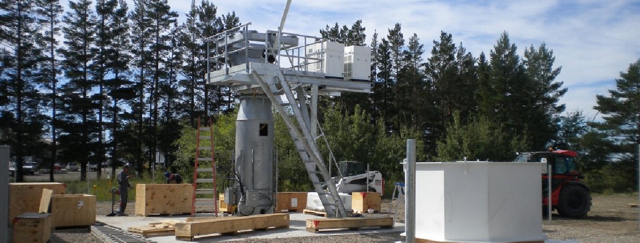 Antenna pedestal, platform and equipment shelter under construction at a ground station site