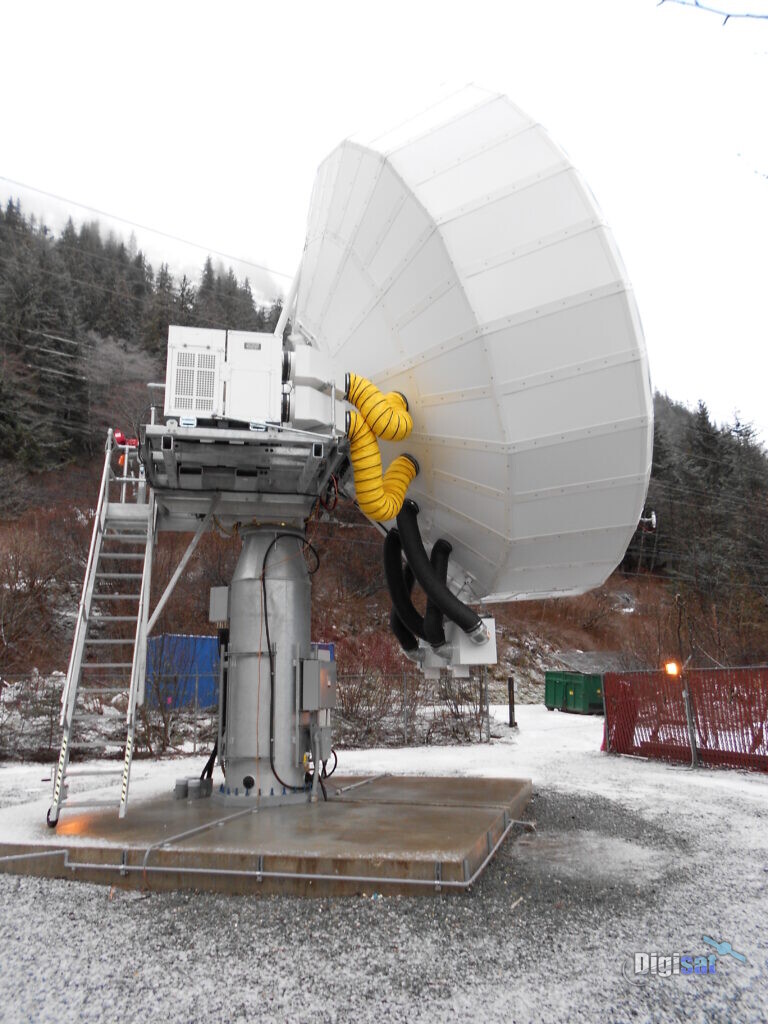 Field crew working on an earth station antenna at a winter site