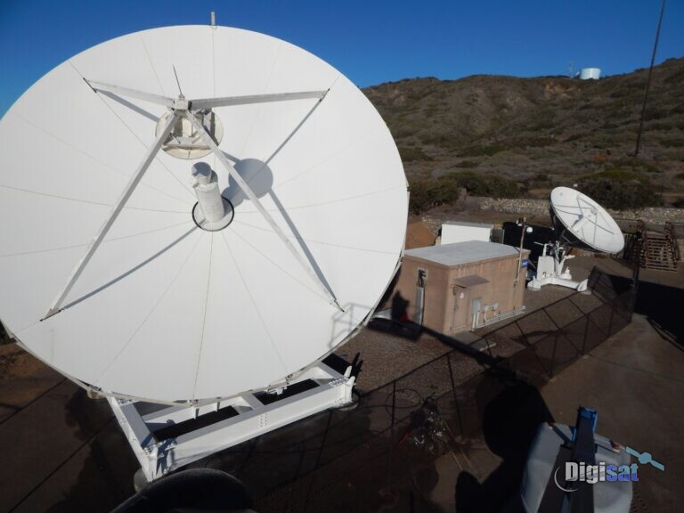 Government ground station antennas beside an equipment shelter