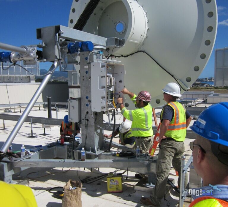 Crew installing a feed on a large teleport antenna